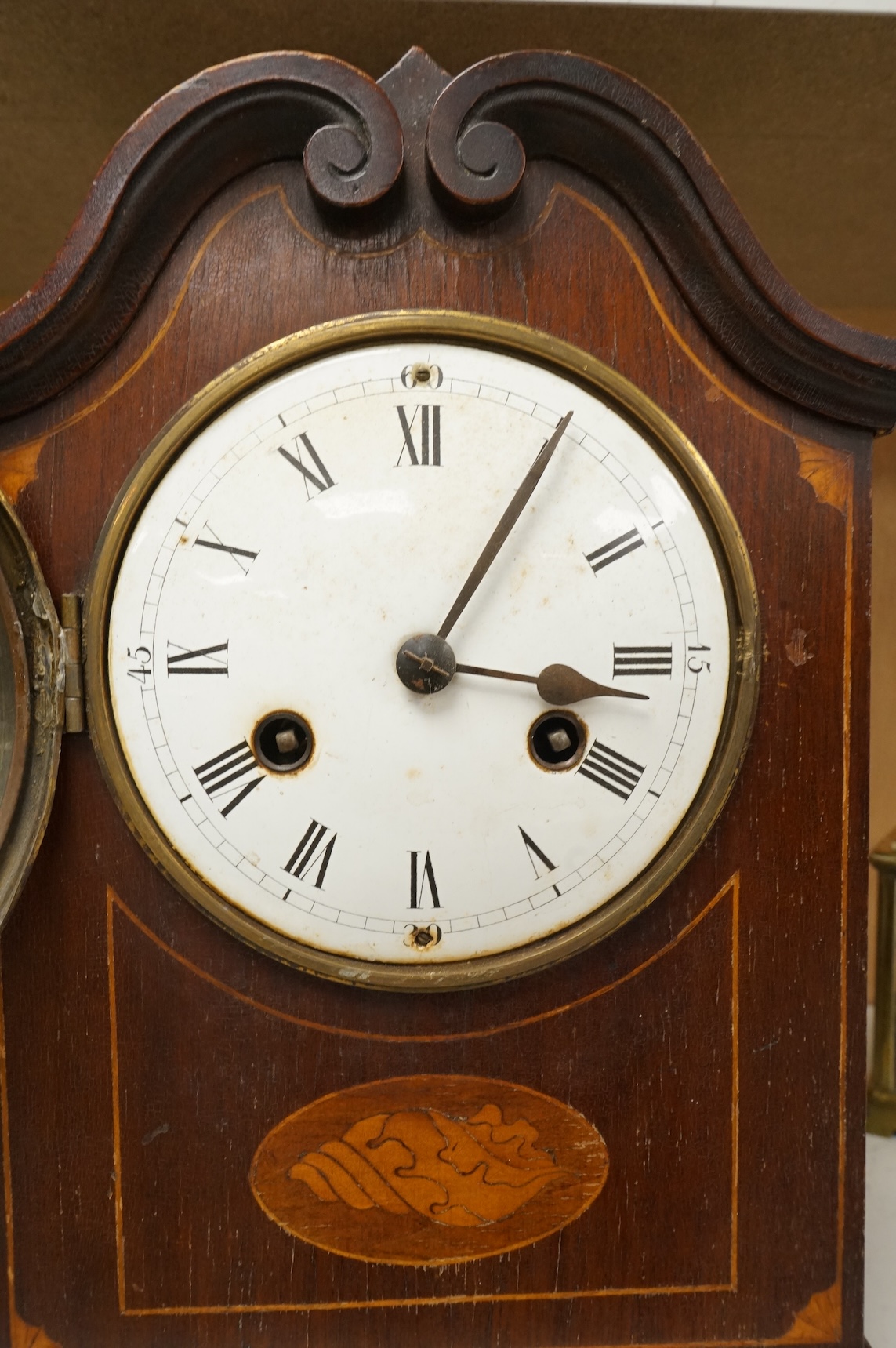 An early 20th century inlaid mantel clock with key and pendulum and a brass cased carriage timepiece, largest 32cm high
